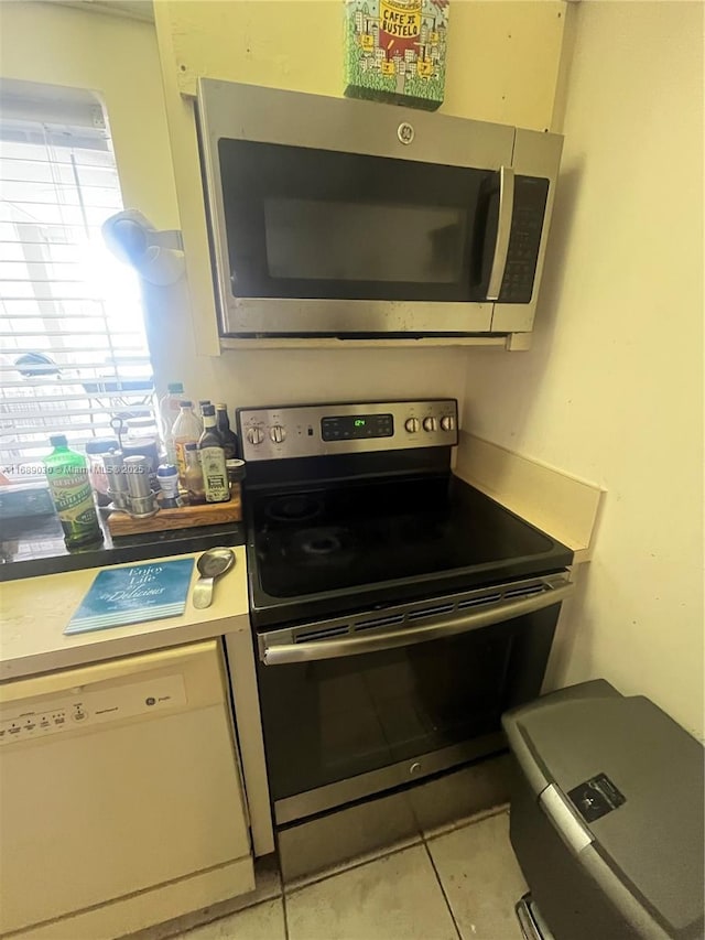 kitchen featuring light tile patterned floors and appliances with stainless steel finishes