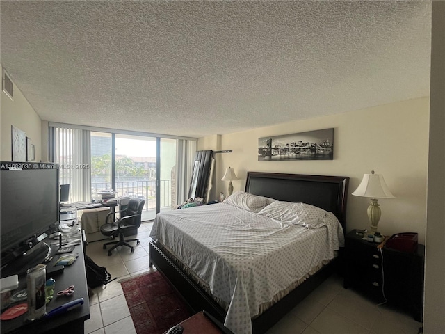 200 Leslie Dr Unit 324, Hallandale Beach, FL 33009 - bedroom with access to exterior, light tile patterned flooring, a desk, floor to ceiling windows, and a textured ceiling