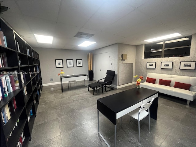 living room featuring a paneled ceiling