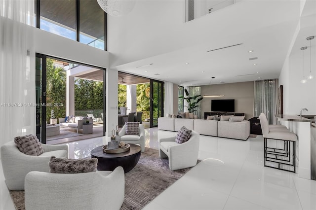 living room featuring a high ceiling and sink