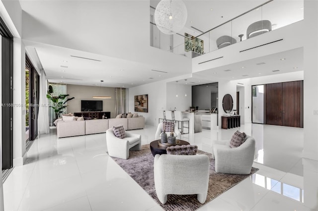 living room featuring plenty of natural light and a high ceiling