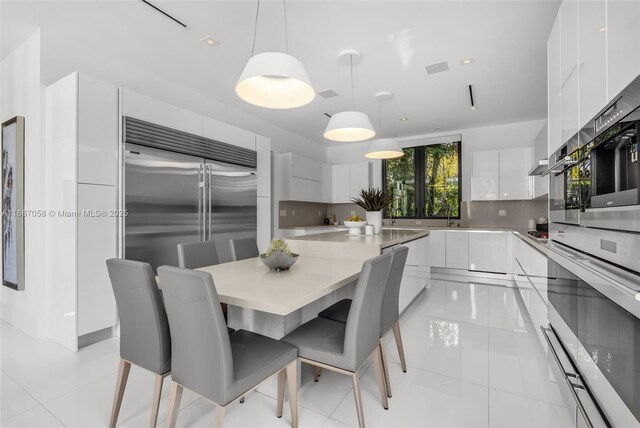 tiled dining space featuring sink