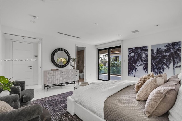 bedroom featuring tile patterned flooring, ensuite bathroom, and access to exterior