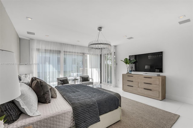 bedroom with light tile patterned floors and a chandelier