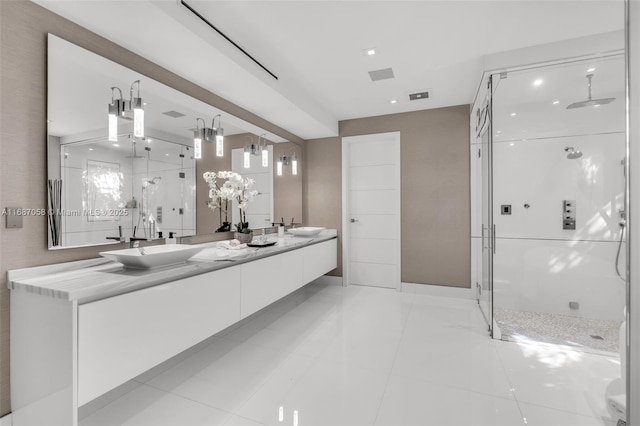 bathroom featuring vanity, tile patterned floors, and walk in shower