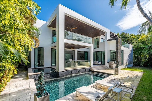 rear view of house featuring ceiling fan, exterior kitchen, a balcony, and a patio