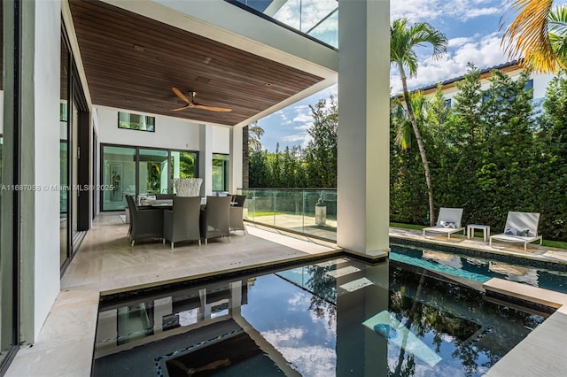 view of swimming pool featuring a patio and ceiling fan