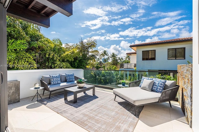 view of patio featuring a balcony and an outdoor hangout area