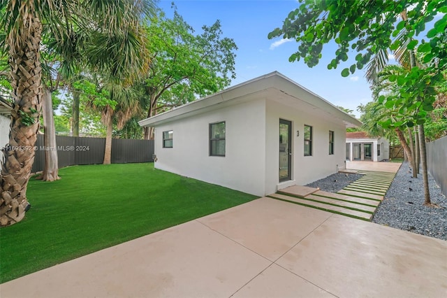 exterior space with a lawn and a patio area