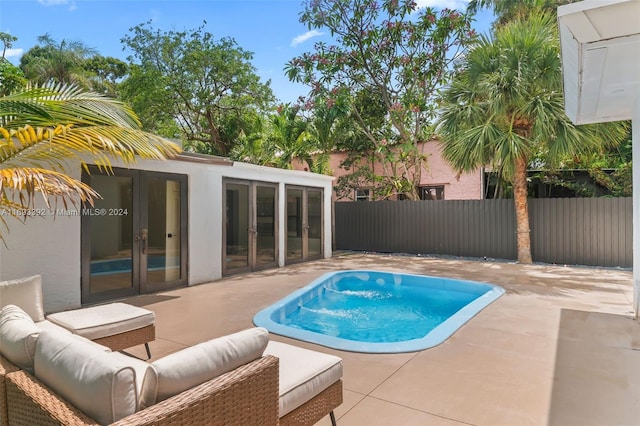 view of pool featuring a patio area and french doors