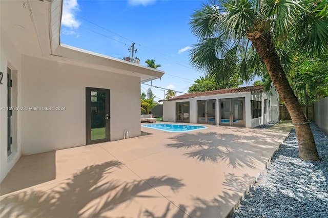 view of pool featuring a patio and an outdoor structure