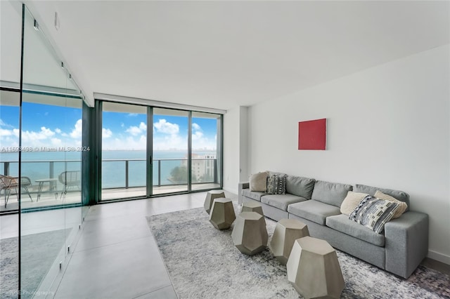 living room with floor to ceiling windows and a water view