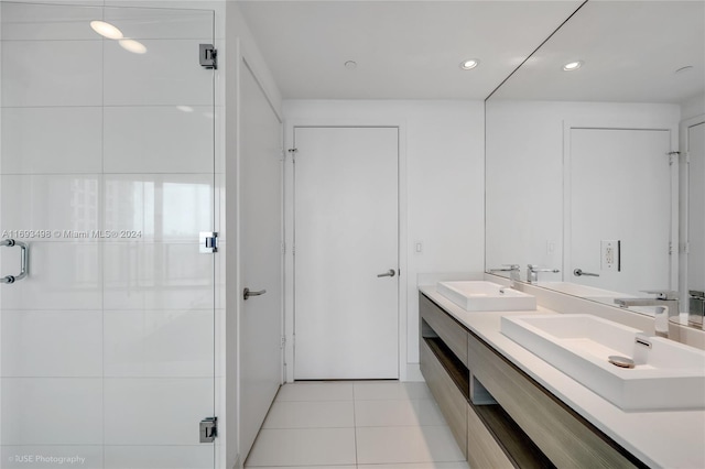 bathroom with tile patterned flooring, vanity, and walk in shower