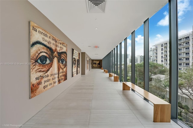 corridor with plenty of natural light and a wall of windows