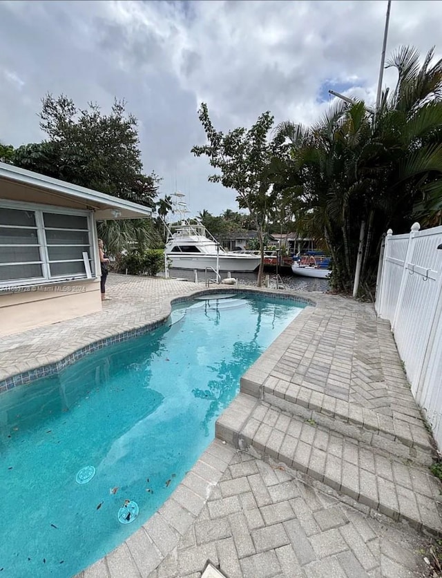 view of swimming pool with a patio