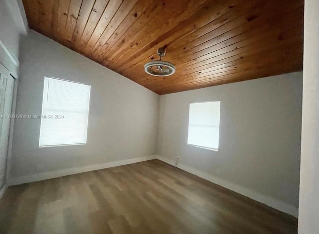 unfurnished room with lofted ceiling, a healthy amount of sunlight, and wood ceiling