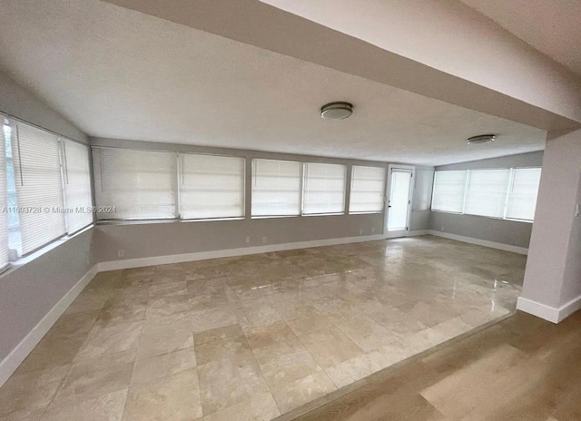 unfurnished room with a textured ceiling