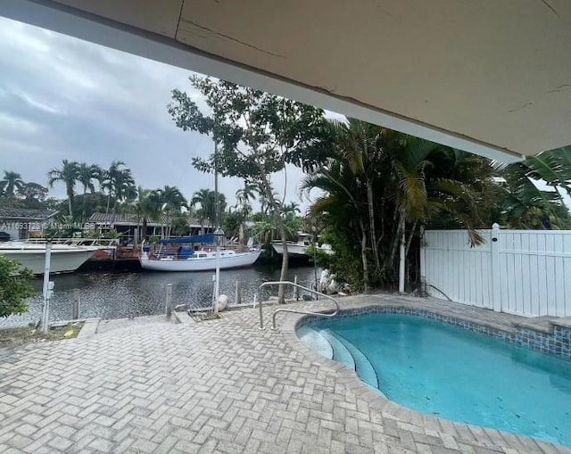 view of swimming pool featuring a water view