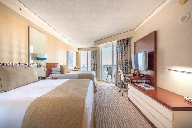 carpeted bedroom featuring a textured ceiling, access to outside, and ornamental molding