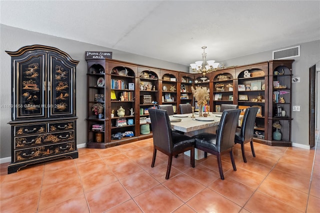 dining area featuring tile patterned floors, a chandelier, and a textured ceiling