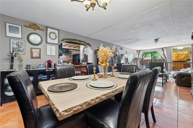 dining room featuring tile patterned floors and a textured ceiling