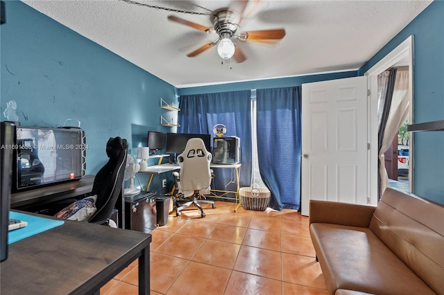 office space with ceiling fan, tile patterned flooring, and a textured ceiling