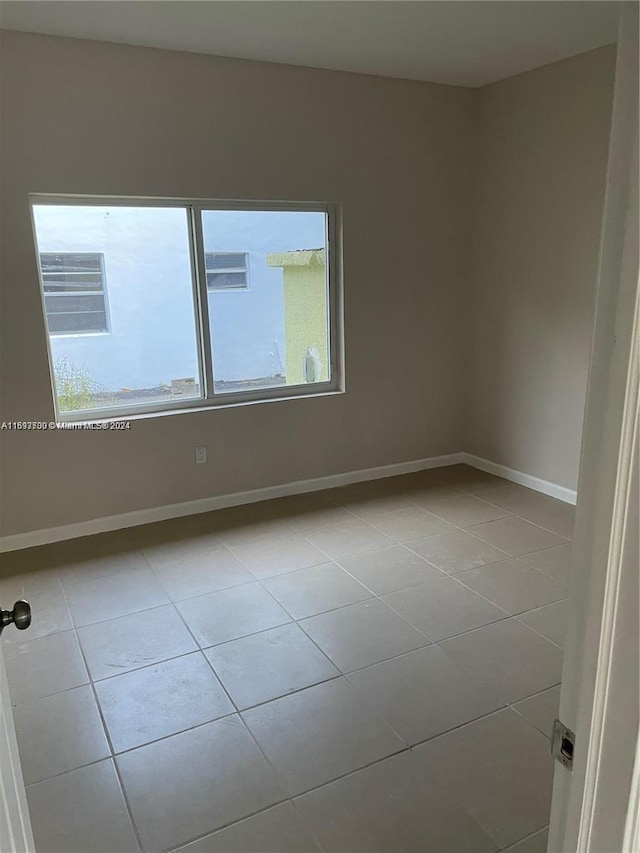 empty room with light tile patterned floors