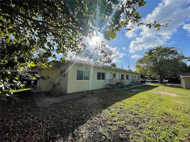 view of side of property with a yard