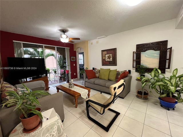 tiled living room featuring a textured ceiling and ceiling fan