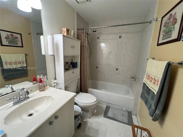 full bathroom featuring tile patterned floors, shower / bath combo with shower curtain, vanity, and toilet