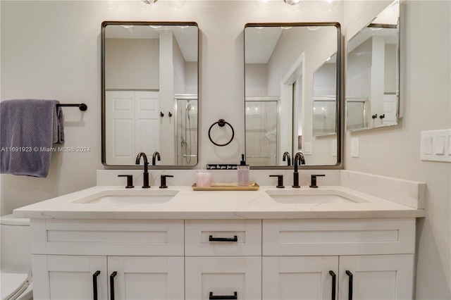 bathroom featuring toilet, an enclosed shower, and vanity