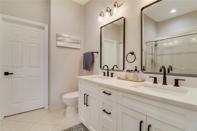 bathroom with tile patterned floors, vanity, toilet, and walk in shower