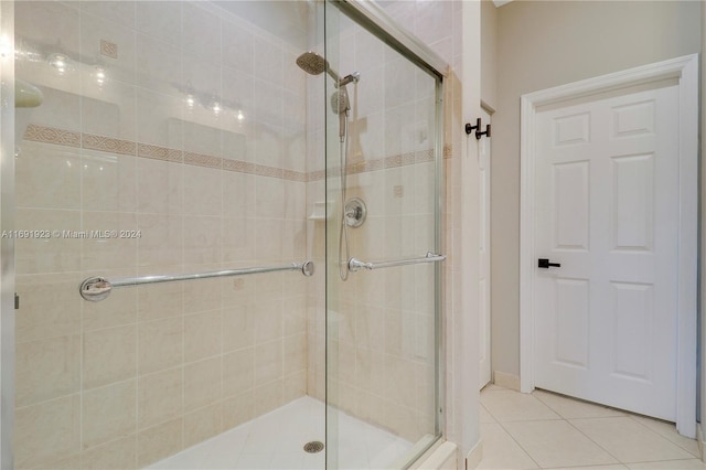 bathroom featuring tile patterned flooring and a shower with door