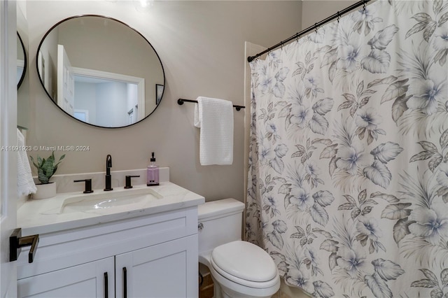 bathroom with vanity, toilet, and curtained shower