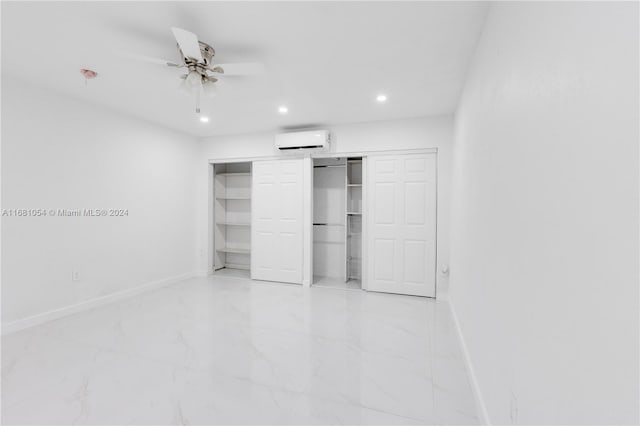 unfurnished bedroom featuring ceiling fan, a wall unit AC, and a closet