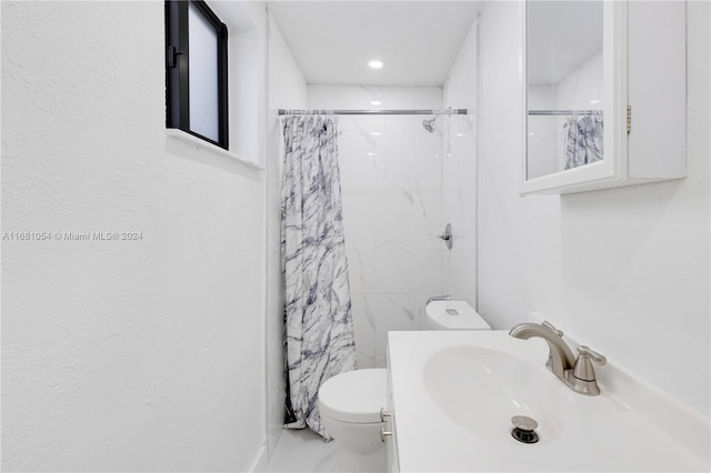 bathroom featuring a shower with shower curtain, toilet, and sink