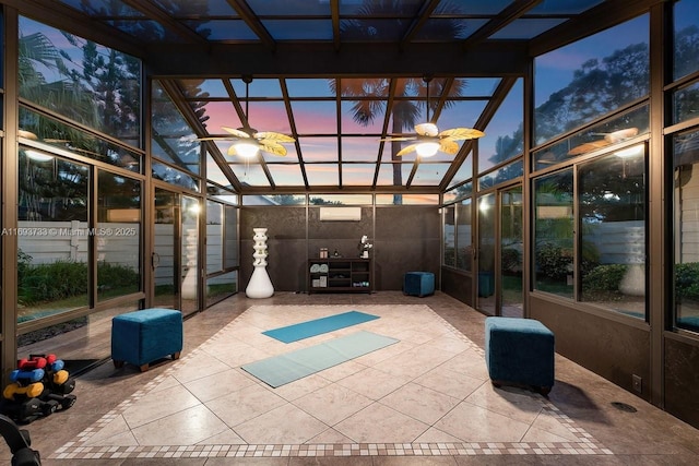 unfurnished sunroom featuring lofted ceiling, a wall unit AC, and ceiling fan