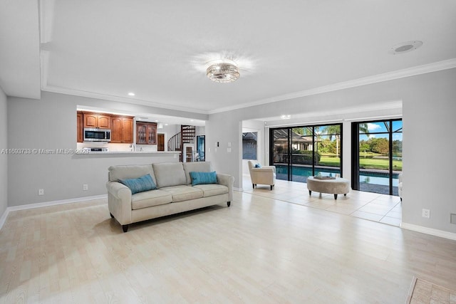 living room featuring crown molding and light hardwood / wood-style floors