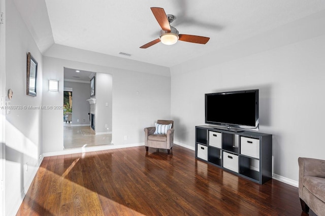 living area with hardwood / wood-style floors and ceiling fan