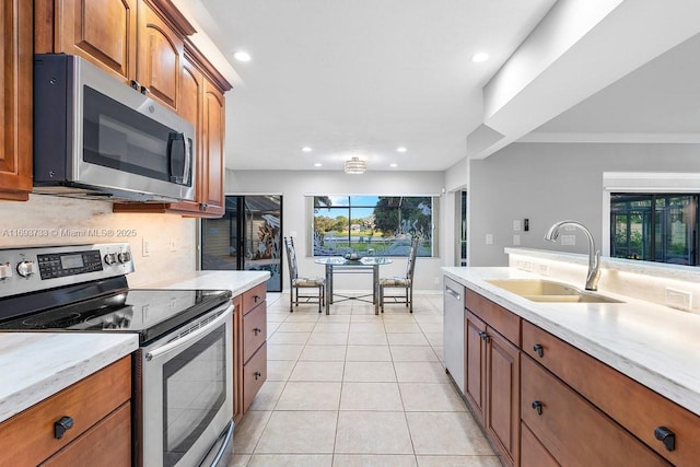 kitchen featuring stainless steel appliances, sink, and light tile patterned floors