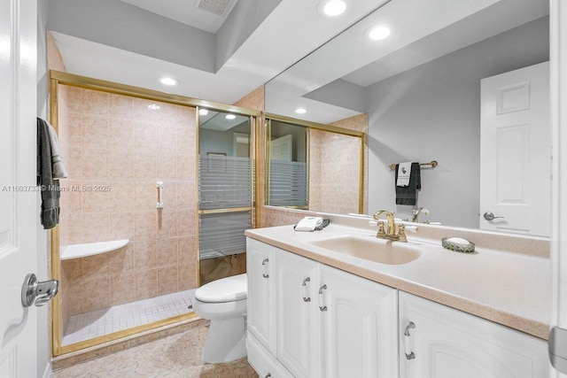 bathroom featuring vanity, toilet, a shower with shower door, and tile patterned flooring