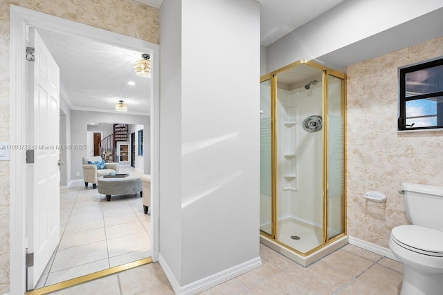 bathroom featuring tile patterned flooring, ornamental molding, a textured ceiling, a shower with shower door, and toilet