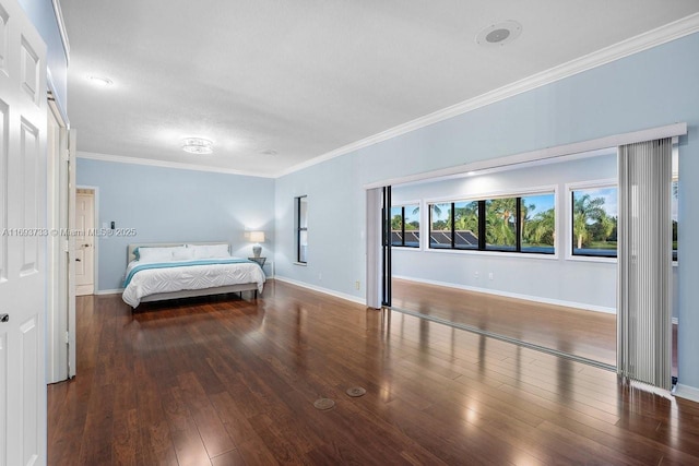 bedroom with crown molding and dark hardwood / wood-style floors