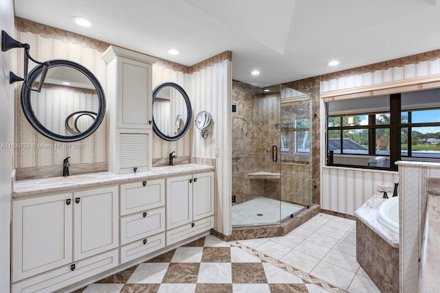 bathroom with vanity and independent shower and bath