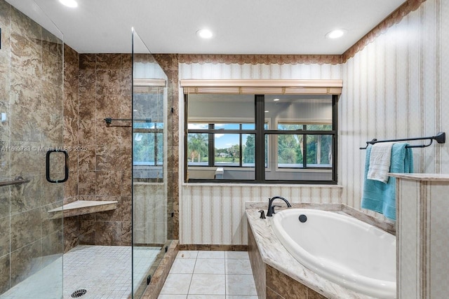 bathroom featuring tile patterned flooring and separate shower and tub