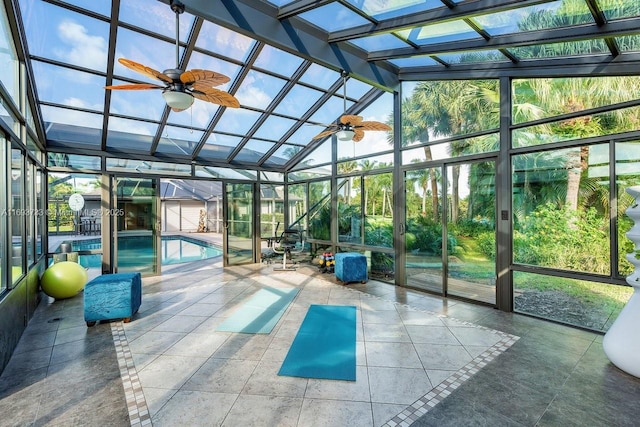 unfurnished sunroom with lofted ceiling, a pool, and ceiling fan