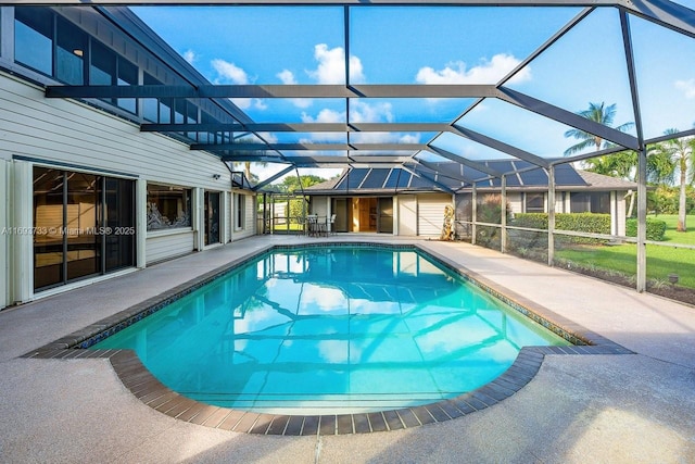 view of swimming pool with a patio and glass enclosure