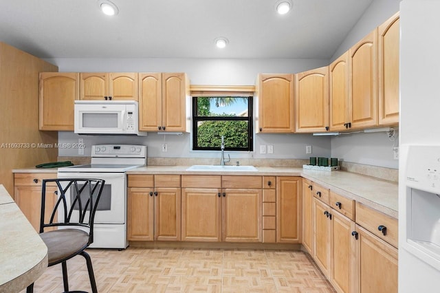 kitchen with light brown cabinetry, sink, white appliances, and light parquet flooring