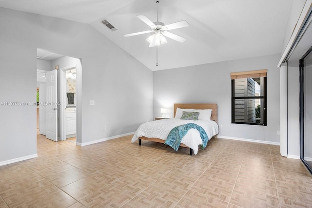 bedroom featuring ceiling fan, lofted ceiling, ensuite bath, and light parquet floors