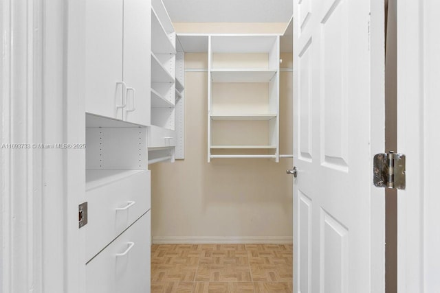 spacious closet with light parquet flooring